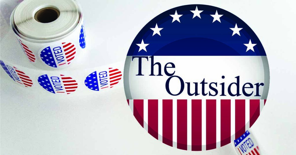 A campaign button that says The Outsider