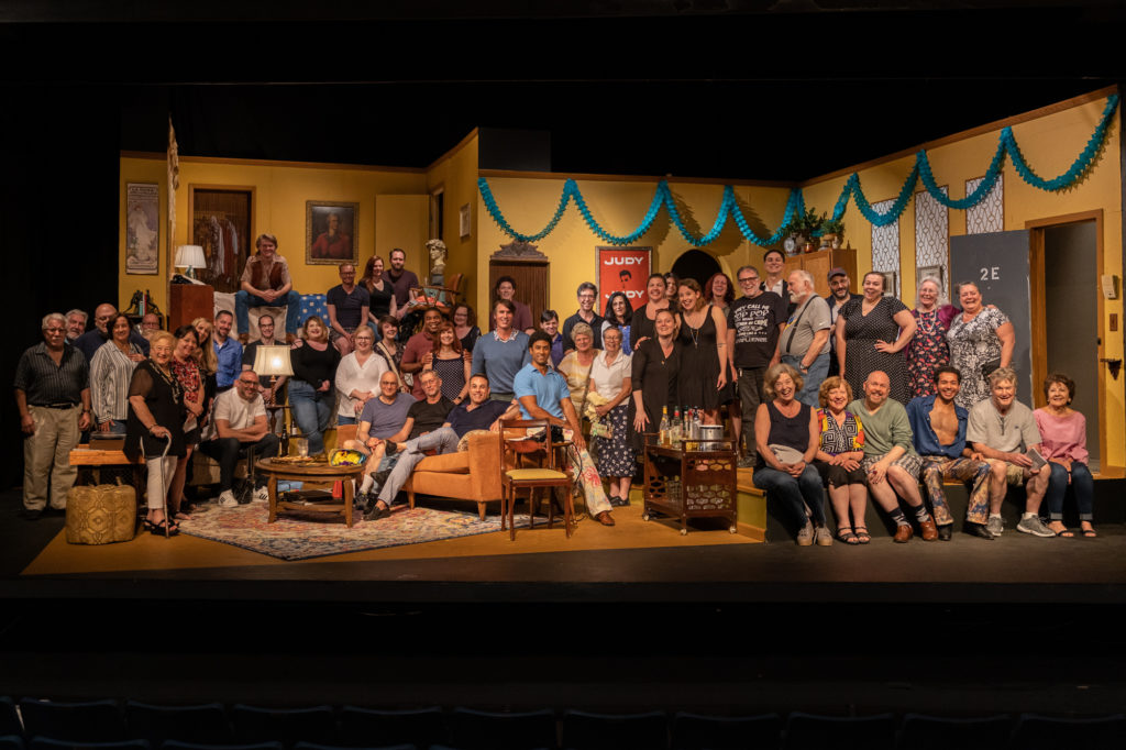 Audience invited on stage for a 50 years of Pride commemorative photo