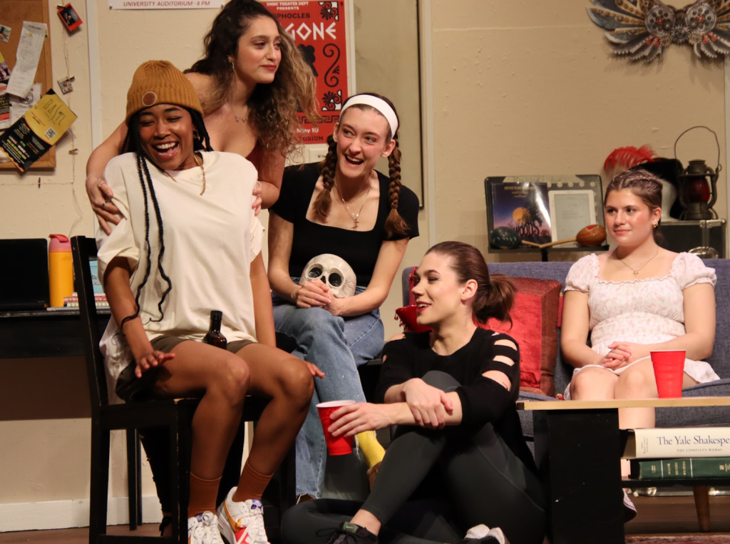 five girls sitting around a sofa during a drunken party