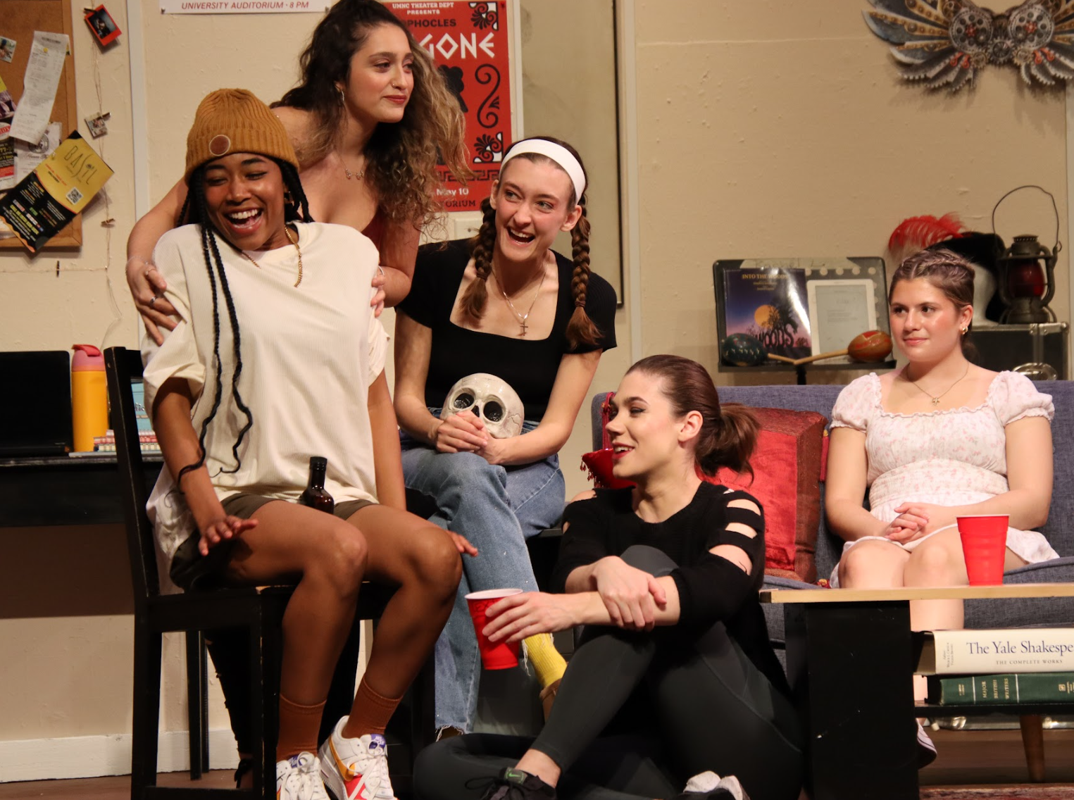 Girls gathered around a living room at a drunken party